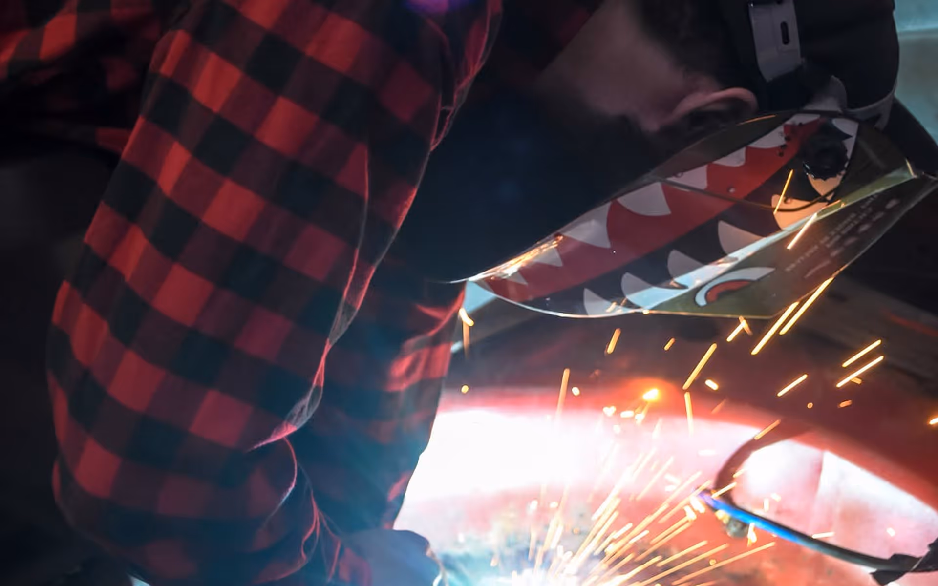 DTM Fabrication welder in action with sparks flying